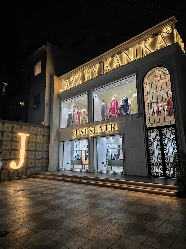 The Just Silver store front at night