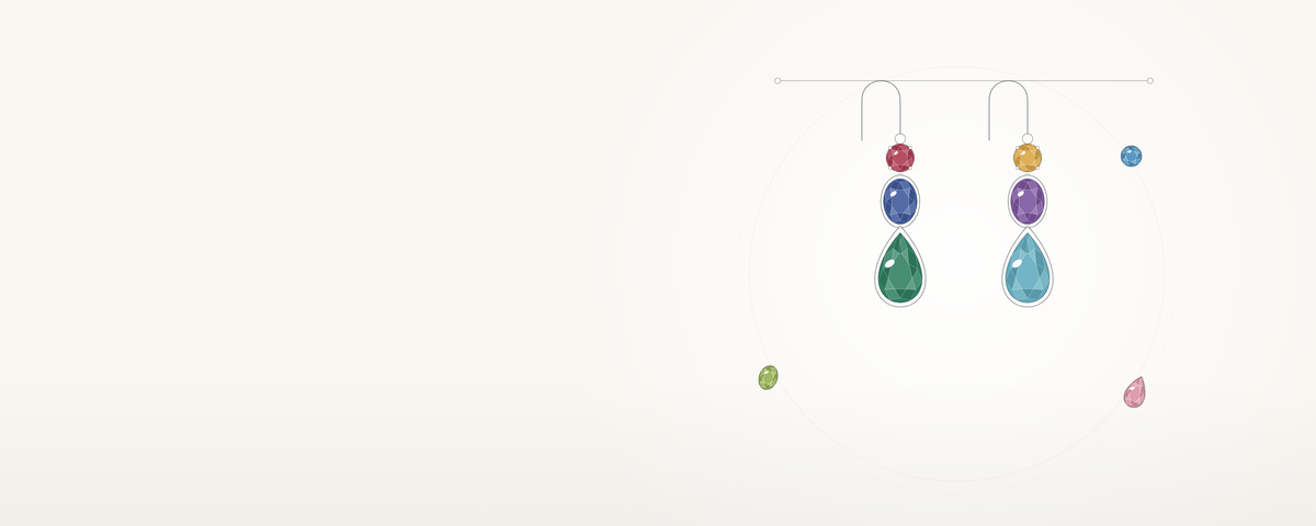 A pair of drop earrings with stones in many colours, on ivory